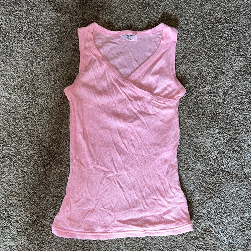 Light pink Michael Stars sleeveless top with crisscross neckline.